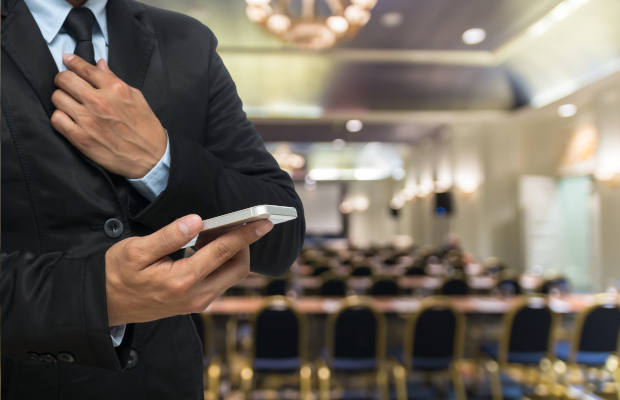 Businessman using the smart phone on the Abstract blurred photo