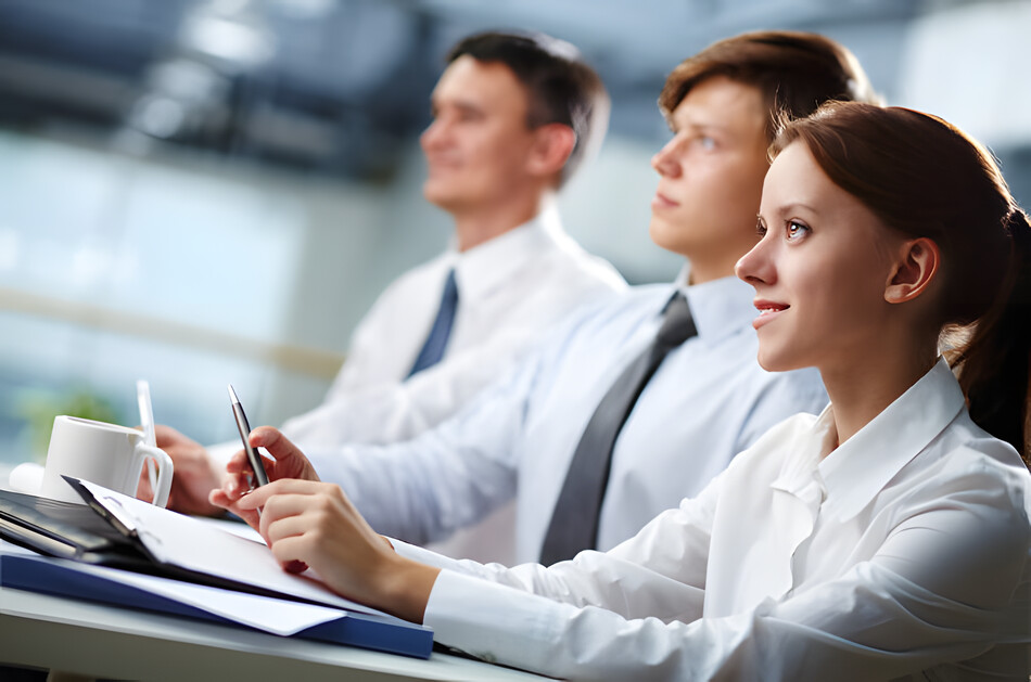 Three business people sitting at a seminar