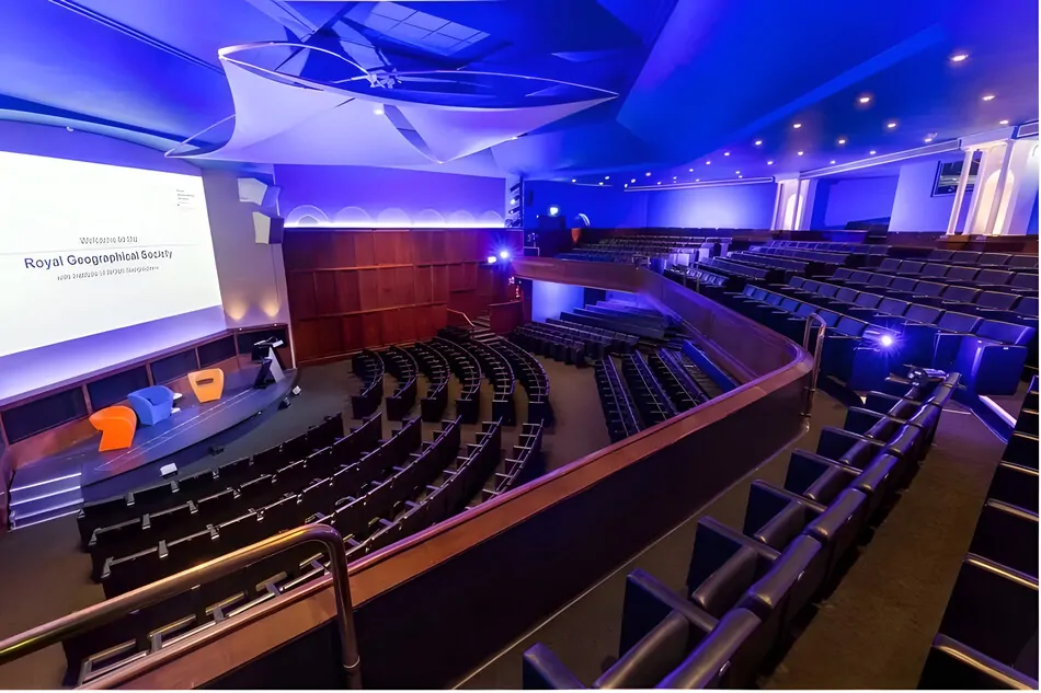 Modern auditorium interior with tiered seating and presentation stage