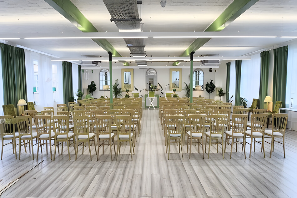 Wedding ceremony setup with chairs in bright indoor venue